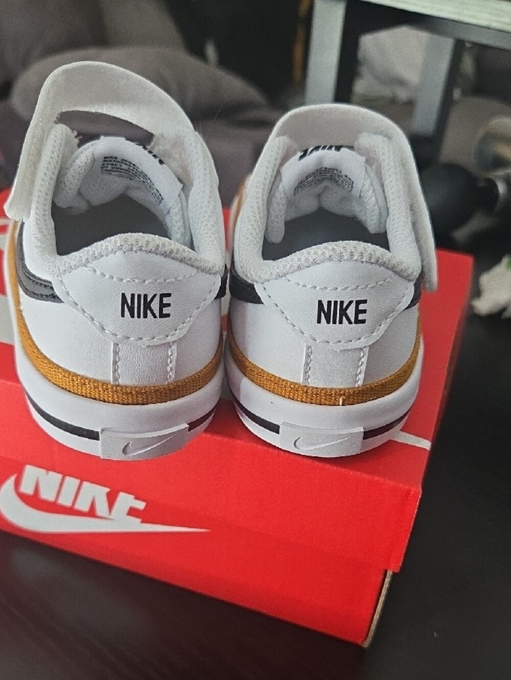 Nike Kids White Sneakers with Black Swoosh and Gold Accent - Picture 5 of 8